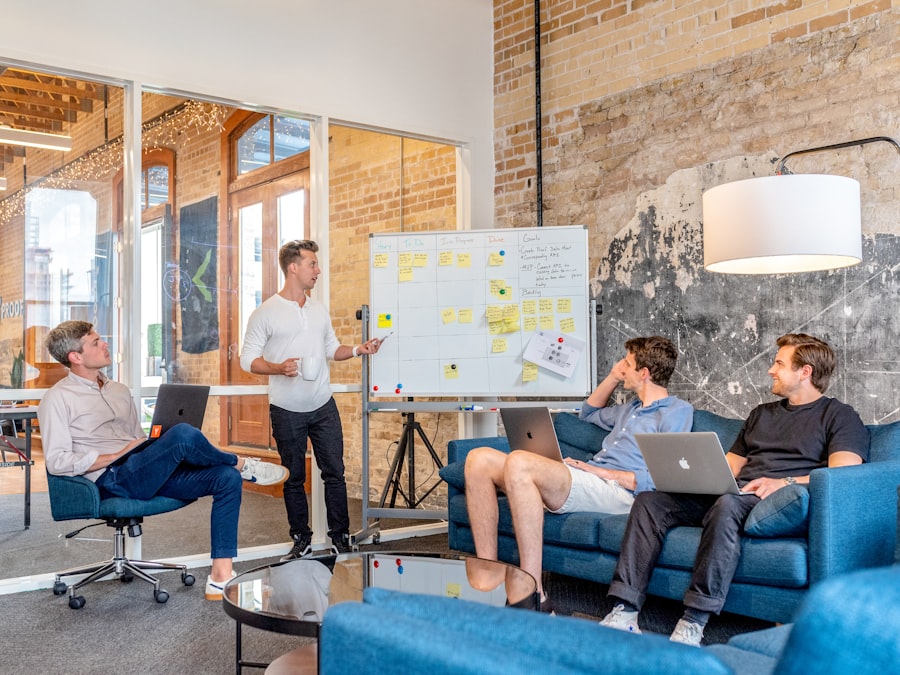 Business coaching โ professionals collaborating around a laptop